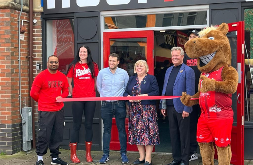 Jane cutting a ribbon to open HoopsHQ