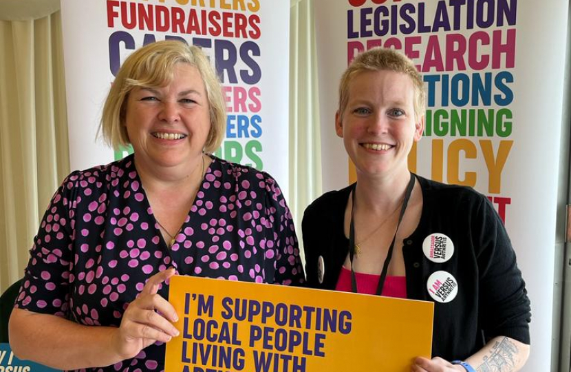 Jane standing with a representative of 'Versus Arthritis'