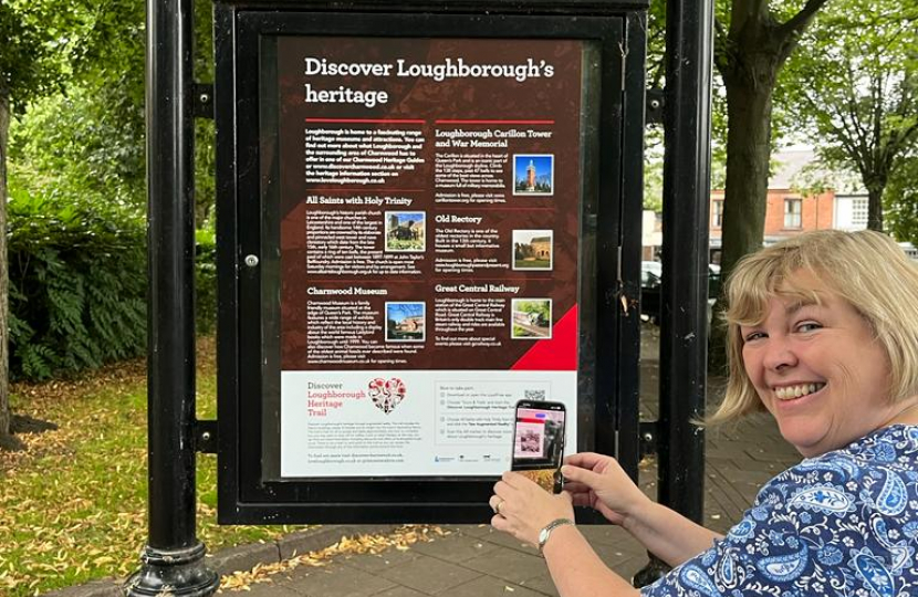 Jane scanning the QR code on the trail board