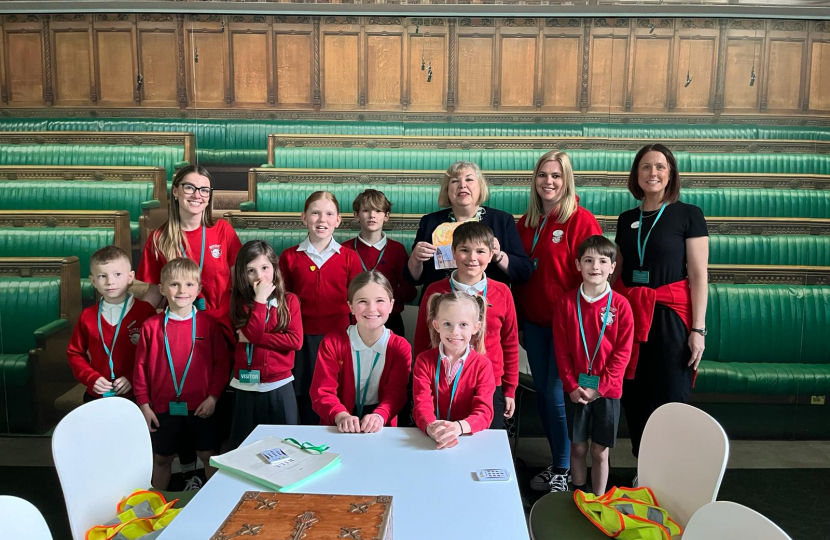 Jane with the students with an image of the house of commons chamber in the background