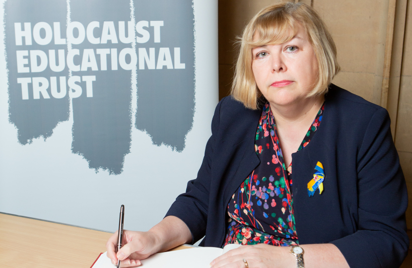 Jane signing the Book of Commitment  