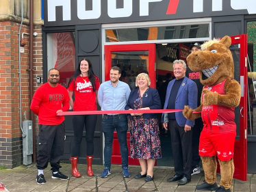 Jane cutting a ribbon to open HoopsHQ