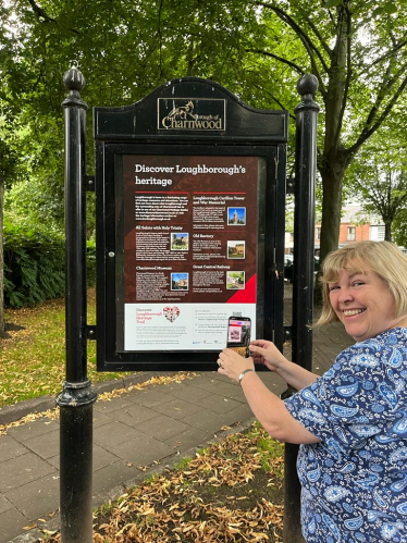 Jane scanning the QR code on the trail board