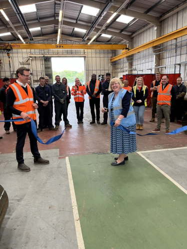 Jane cutting the ribbon in the new building