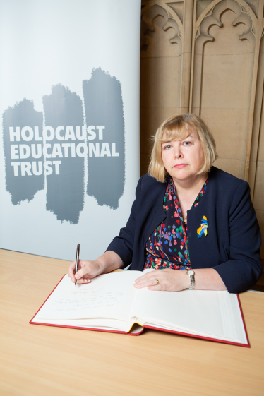 Jane signing the Book of Commitment  